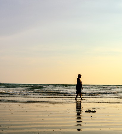 single girl enjoying herself with background of peaceful beach during sunset, photo taken on Ao Nang beach, Krabi, Thailand.の写真素材