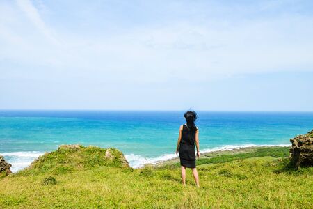 Single Asian girl having fun at Longpan Park, Kenting, Taiwanの写真素材