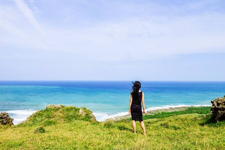Single Asian girl having fun at Longpan Park, Kenting, Taiwanの写真素材