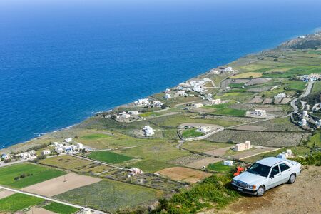Beautiful landscape of Spring blossoms in Greek village by Aeagon seaの写真素材