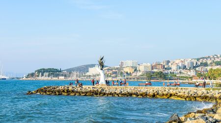 Kusadasi / Turkey - Oct 5, 2015: local people enjoying life around signature sculpture at the coastlineのeditorial素材