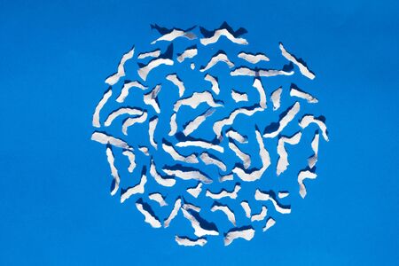 white paper torn on blue paper backgroundの写真素材