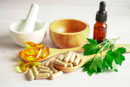 Alternative medicine herbal organic capsule with vitamin E omega 3 fish oil, mineral, drug with herbs leaf natural supplements for healthy good life.の写真素材