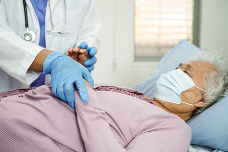 Doctor check Asian elder senior woman patient wearing a mask for protect covid coronavirus.の写真素材