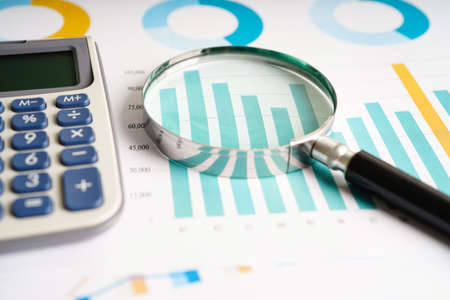 Calculator on chart and graph spreadsheet paper. Finance development, Banking Account, Statistics,...