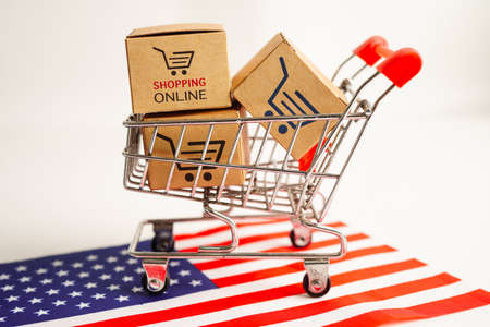 Online shopping, Shopping cart box on USA America flag, import export, finance commerce.の写真素材