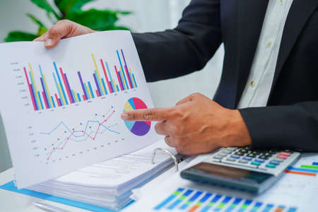 Businessman working and analysis with statistic graph in office.の写真素材