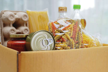 Foodstuffs in donation box for volunteer.の写真素材