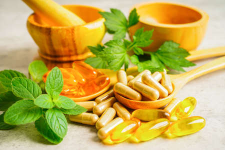 Alternative medicine herbal organic capsule with vitamin E omega 3 fish oil, mineral, drug with herbs leaf natural supplements for healthy good life.の写真素材