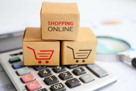 Online shopping, Shopping cart box on calculator, import export, finance commerce.の写真素材