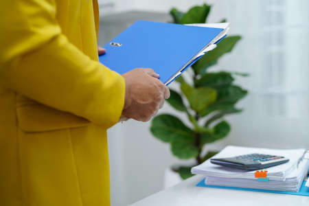 Businessman working and prepare paperwork report data to analysis information in file binder at office.の写真素材