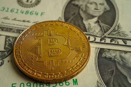 Golden bitcoin on US dollar banknotes money for business and commercial, Digital currency, Virtual cryptocurrency, blockchain technology.の写真素材