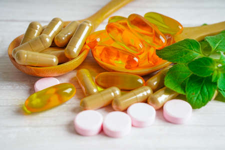 Alternative medicine herbal organic capsule with vitamin E omega 3 fish oil, mineral, drug with herbs leaf natural supplements for healthy good life.の写真素材