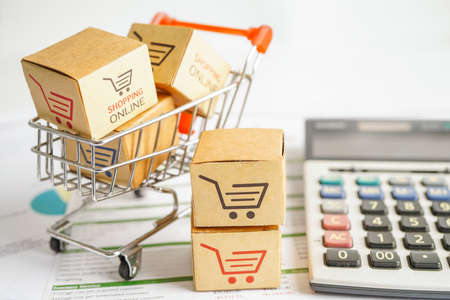 Online shopping, Shopping cart box on calculator, import export, finance commerce.の写真素材