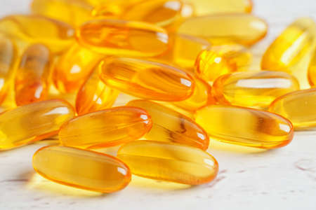 Fish oil or Cod liver oil gel in capsules with omega 3 vitamins, supplementary healthy foodの写真素材