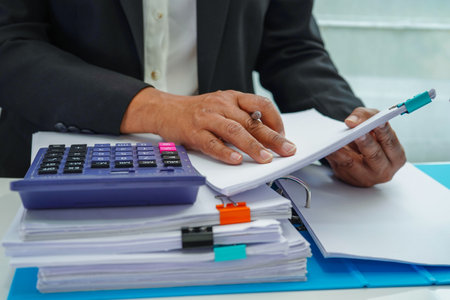 Businessman working and prepare paperwork report data to analysis information in file binder at office.の写真素材