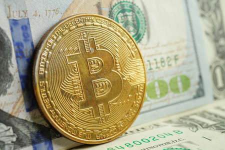 Golden bitcoin on US dollar banknotes money for business and commercial, Digital currency, Virtual cryptocurrency, blockchain technology.の写真素材