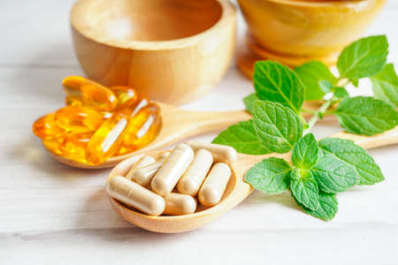 Alternative medicine herbal organic capsule with vitamin E omega 3 fish oil, mineral, drug with herbs leaf natural supplements for healthy good life.の写真素材