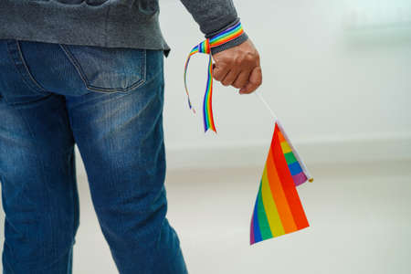 Asian woman with rainbow flag, LGBT symbol rights and gender equality, LGBT Pride Month in June.の写真素材