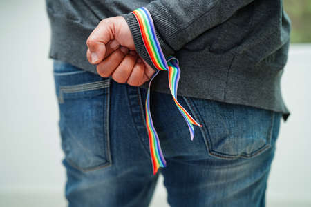 Asian woman with rainbow flag, LGBT symbol rights and gender equality, LGBT Pride Month in June.の写真素材