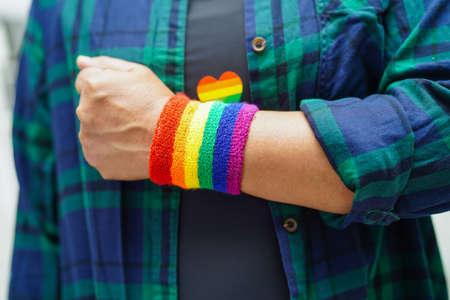 Asian woman with rainbow flag, LGBT symbol rights and gender equality, LGBT Pride Month in June.の写真素材