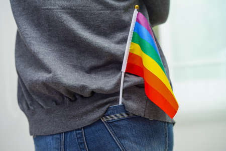 Asian woman with rainbow flag, LGBT symbol rights and gender equality, LGBT Pride Month in June.の写真素材
