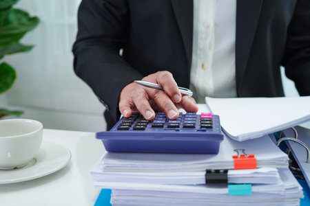 Businessman working and prepare paperwork report data to analysis information in file binder at office.の写真素材