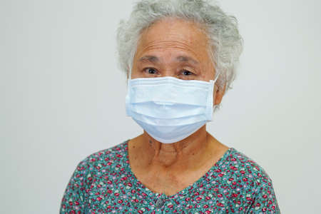 Asian elderly woman patient wearing a mask for protect virus.の写真素材