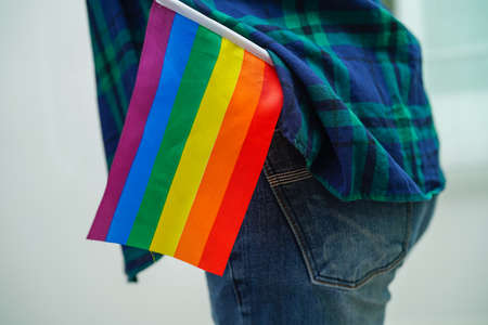 Asian woman with rainbow flag, LGBT symbol rights and gender equality, LGBT Pride Month in June.の写真素材