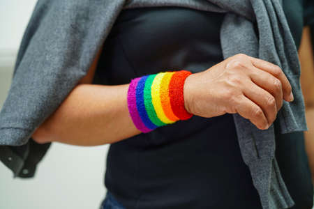 Asian woman with rainbow flag, LGBT symbol rights and gender equality, LGBT Pride Month in June.の写真素材