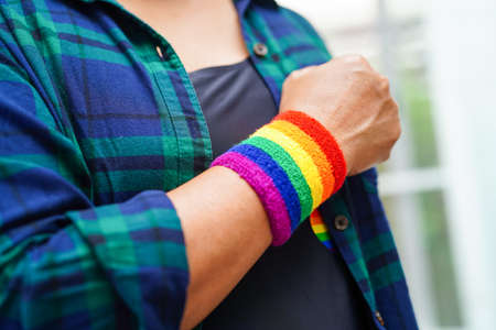 Asian woman with rainbow flag, LGBT symbol rights and gender equality, LGBT Pride Month in June.の写真素材