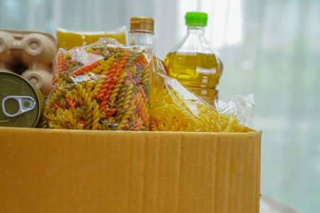Foodstuffs in donation box for volunteer.の写真素材