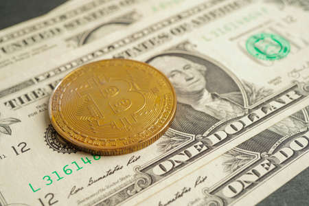 Golden bitcoin on US dollar banknotes money for business and commercial, Digital currency, Virtual cryptocurrency, blockchain technology.の写真素材