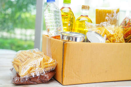Foodstuffs in donation box for volunteer.の写真素材