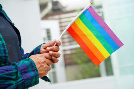 Asian woman with rainbow flag, LGBT symbol rights and gender equality, LGBT Pride Month in June.の写真素材
