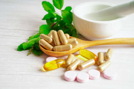 Alternative medicine herbal organic capsule with vitamin E omega 3 fish oil, mineral, drug with herbs leaf natural supplements for healthy good life.の写真素材
