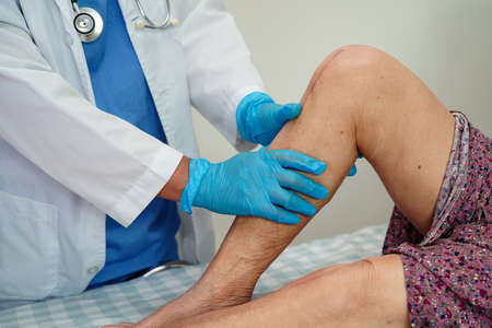 Asian elderly woman patient with scar knee replacement surgery in hospital.の写真素材