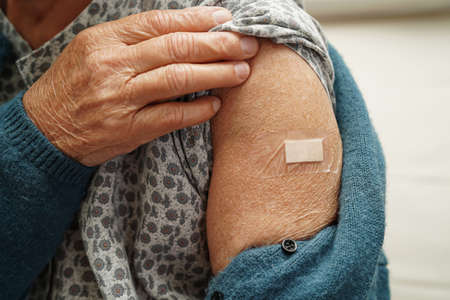 Asian elder senior woman getting vaccine for protect corona virus.の写真素材