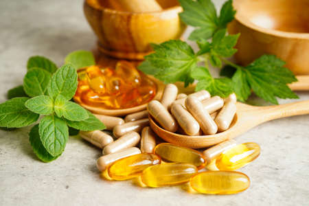 Alternative medicine herbal organic capsule with vitamin E omega 3 fish oil, mineral, drug with herbs leaf natural supplements for healthy good life.の写真素材