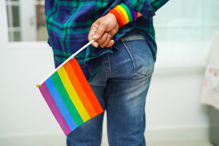 Asian woman with rainbow flag, LGBT symbol rights and gender equality, LGBT Pride Month in June.の写真素材