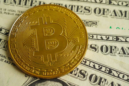 Golden bitcoin on US dollar banknotes money for business and commercial, Digital currency, Virtual cryptocurrency, blockchain technology.の写真素材