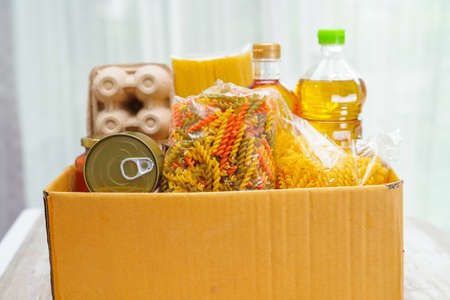 Foodstuffs in donation box for volunteer.の写真素材
