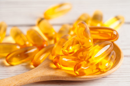 Fish oil or Cod liver oil gel in capsules with omega 3 vitamins, supplementary healthy foodの写真素材