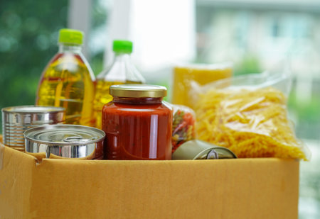 Foodstuffs in donation box for volunteer.の写真素材
