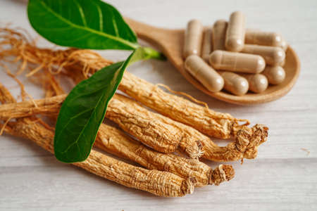 Ginseng roots and green leaf, healthy food.の写真素材
