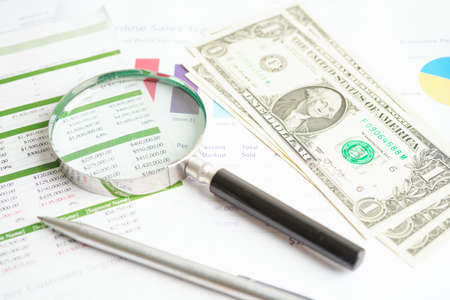 Magnifying glass on US dollar and EURO banknotes and graph, finance business trade concept.の写真素材