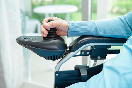 Asian elderly woman disability patient walk with walker in nursing hospital, medical concept.の写真素材