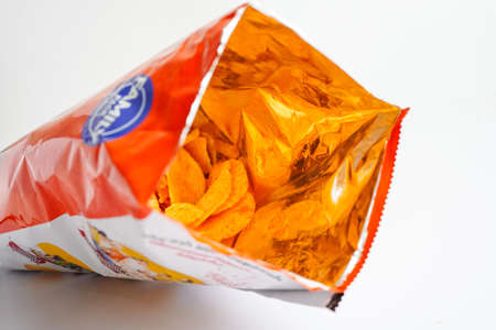 Potato chips in open bag, delicious BBQ seasoning spicy for crips, thin slice deep fried snack fast food.の写真素材