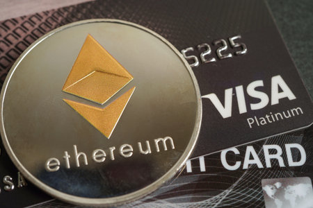 Bangkok, Thailand - December 15, 2021 Golden bitcoin with credit card on US dollar banknotes money...