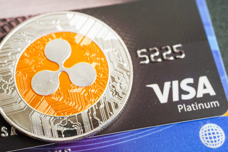 Bangkok, Thailand - December 15, 2021 Golden bitcoin with credit card on US dollar banknotes money for business and commercial, Digital currency, Virtual cryptocurrency.のeditorial素材